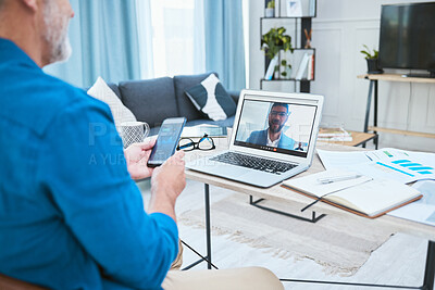 Buy stock photo Shot of a mature businessman making a video call using his laptop