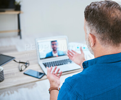 Buy stock photo Shot of a mature businessman making a video call using his laptop