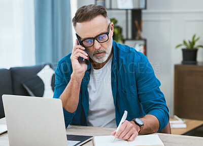 Buy stock photo Shot of a mature businessman working from home while making a phone call