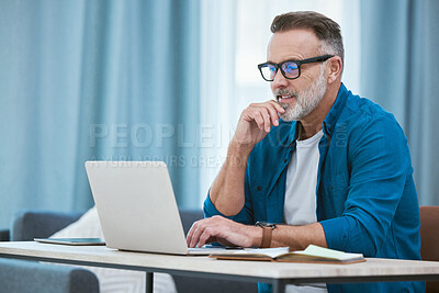 Buy stock photo Shot of a mature businessman working from home using his laptop