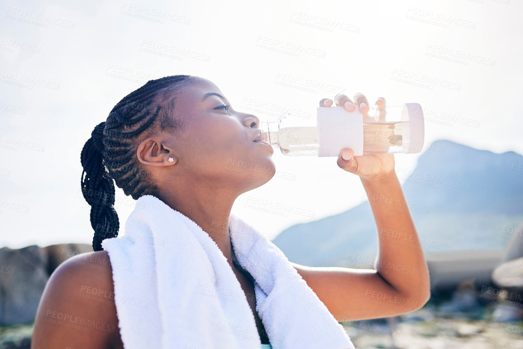 Buy stock photo Woman, exercise break and drinking water in outdoor for marathon training, tired runner and wellness. Female athlete, thirsty and bottle with liquid for hydration, running and workout rest in nature