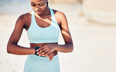 Buy stock photo Shot of an athletic young woman checking her wristwatch