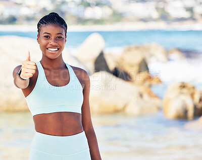 Buy stock photo Shot of a fit young woman showing thumbs up while standing outside