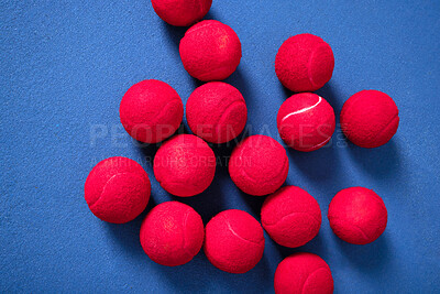 Buy stock photo Training, floor and tennis balls for game or sport, practice and workout for skill development for tournament or match. Blue court or pitch, red equipment and ground for athletic activity and fitness