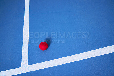 Buy stock photo Single, ground and tennis ball for sport or game, practice and training for skill development for tournament or match. Blue court or pitch, red equipment and floor for athletic activity and fitness.