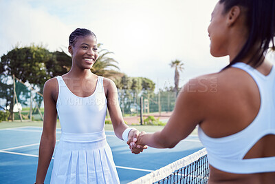 Buy stock photo Shot of two attractive women shaking hands while playing tennis outside
