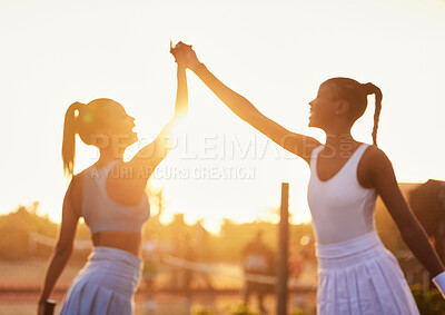 Buy stock photo High five, women and win on tennis court for fitness, success and sportsmanship at sunset. Girl team, hands together and celebrate for victory in sport, motivation and achievement in competition