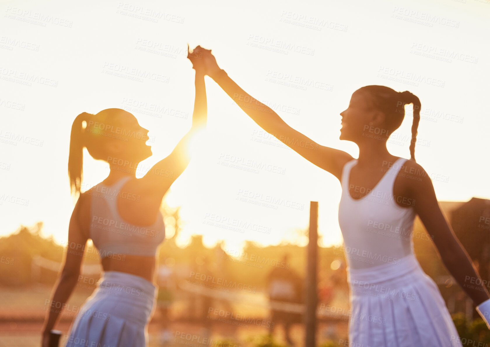 Buy stock photo High five, women and win on tennis court for fitness, success and sportsmanship at sunset. Girl team, hands together and celebrate for victory in sport, motivation and achievement in competition