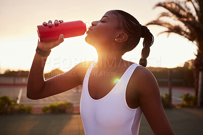 Buy stock photo Bottle, outdoor and black girl with water, athlete or hydration on break of practice of tennis. Fitness, sunset and woman in sports, club and ready for tournament, workout or training of professional