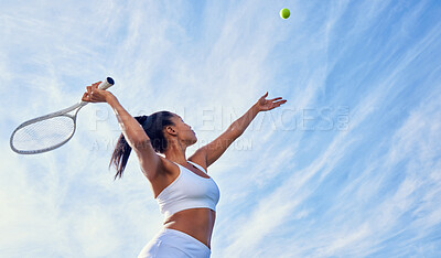 Buy stock photo Shot of an attractive young woman playing tennis outside