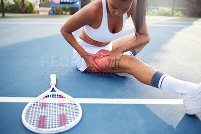 Buy stock photo Shot of an unrecognizable woman sitting alone and stretching before playing tennis