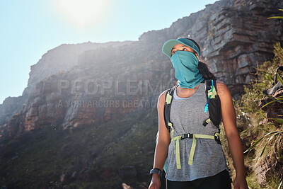 Buy stock photo Nature, backpack and woman hiking in mountain for adventure, fitness or discovery for geology. Mask, exercise and female person trekking for outdoor hobby, workout or activity by rocks in New Zealand