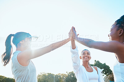 Buy stock photo Shot of a group of young women sharing a high five while out playing tennis