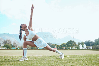 Buy stock photo Shot of a young woman stretching while out playing tennis