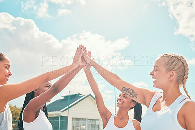 Buy stock photo Shot of a diverse group of women standing together with their hands raised in the middle during tennis practise