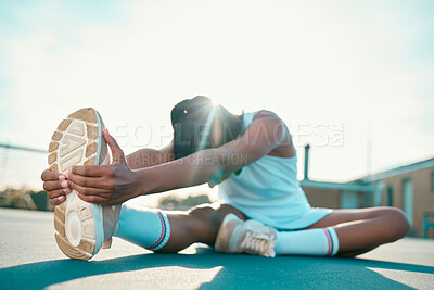 Buy stock photo Full length shot of an unrecognisable woman sitting alone on a tennis court and stretching before practise