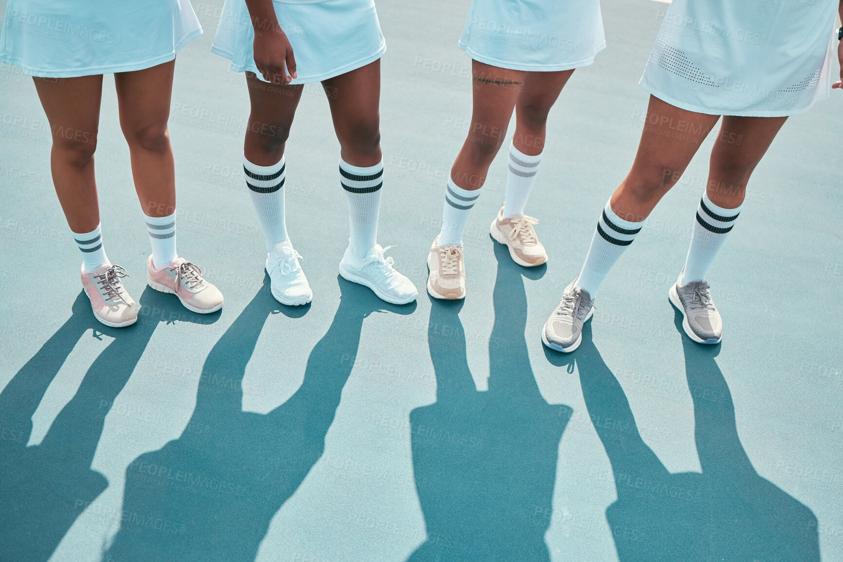 Buy stock photo High angle shot of an unrecognisable group of women standing together after tennis practise