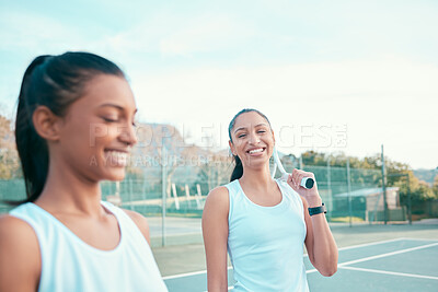 Buy stock photo Shot of two young woman standing together after playing tennis