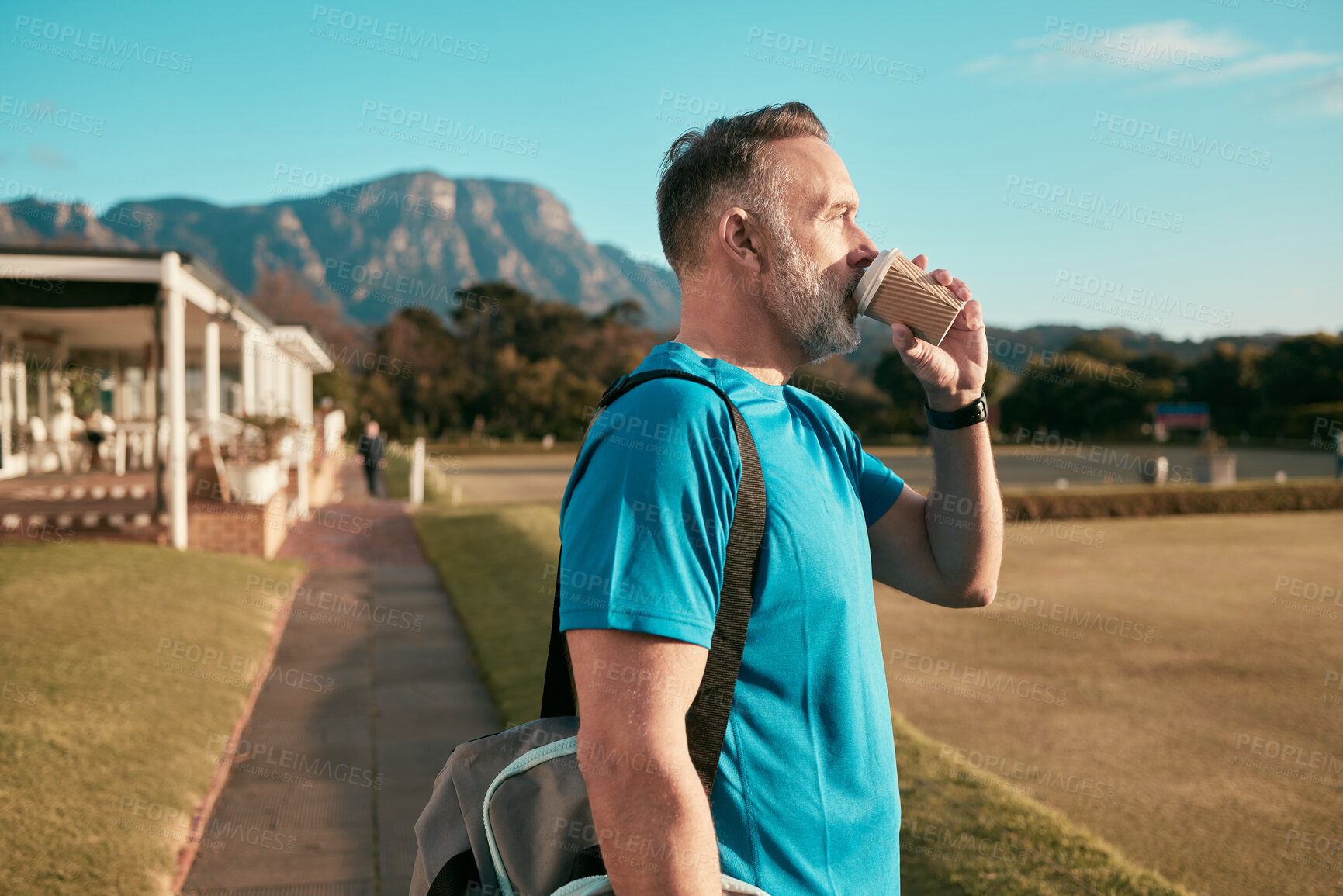Buy stock photo Shot of a handsome mature coach standing alone outside and enjoying a cup of coffee