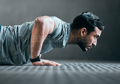 Buy stock photo Cropped shot of a handsome young male athlete doing pushups against a grey background