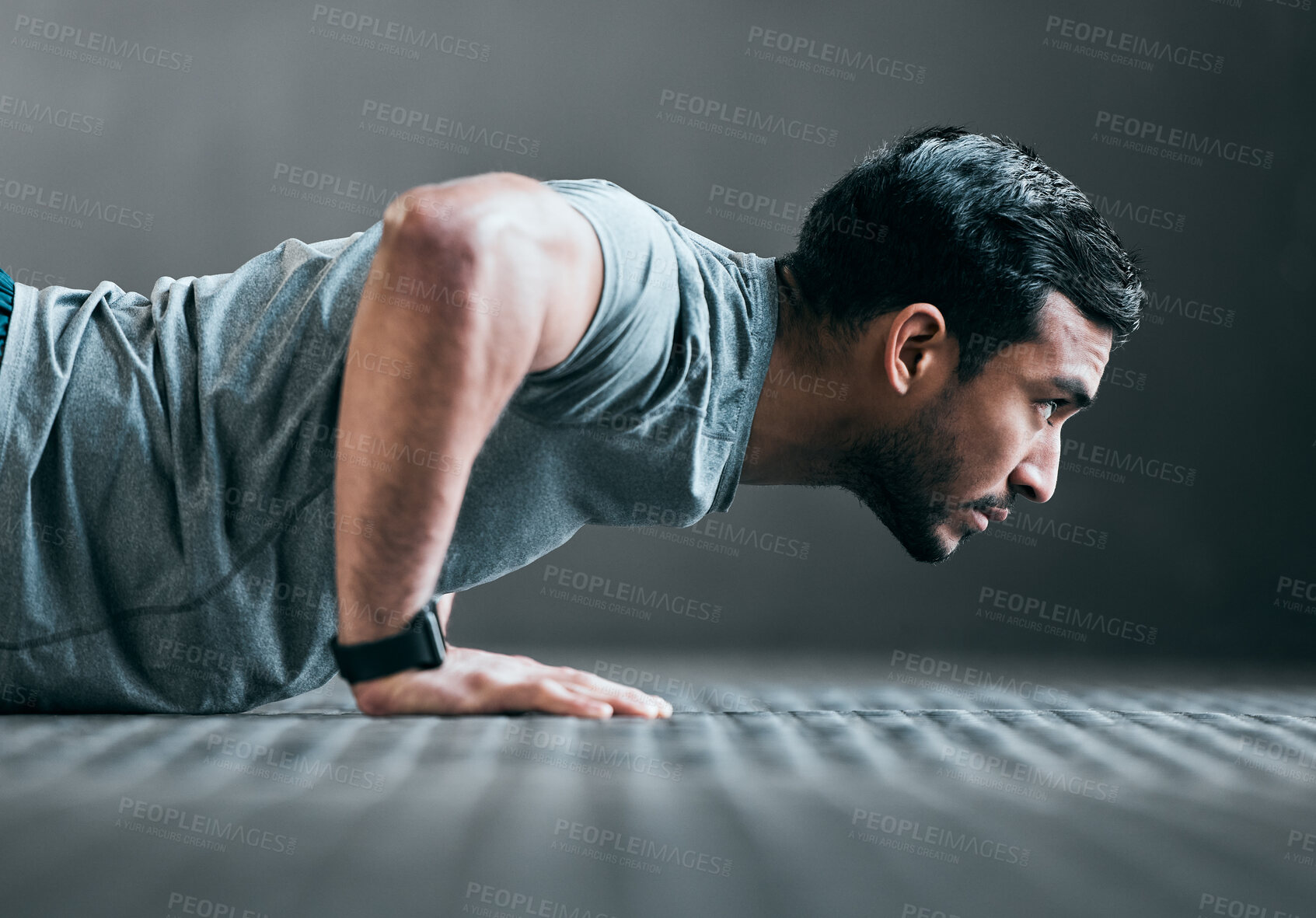 Buy stock photo Cropped shot of a handsome young male athlete doing pushups against a grey background
