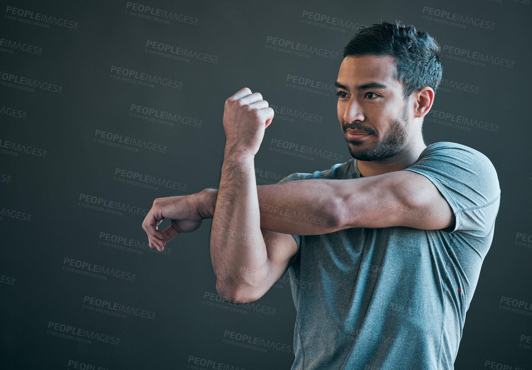 Buy stock photo Stretching arms, fitness and man in gym for exercise, training and warm up for athlete workout. Health, sports and isolated person thinking for wellness, performance or flexibility on gray background