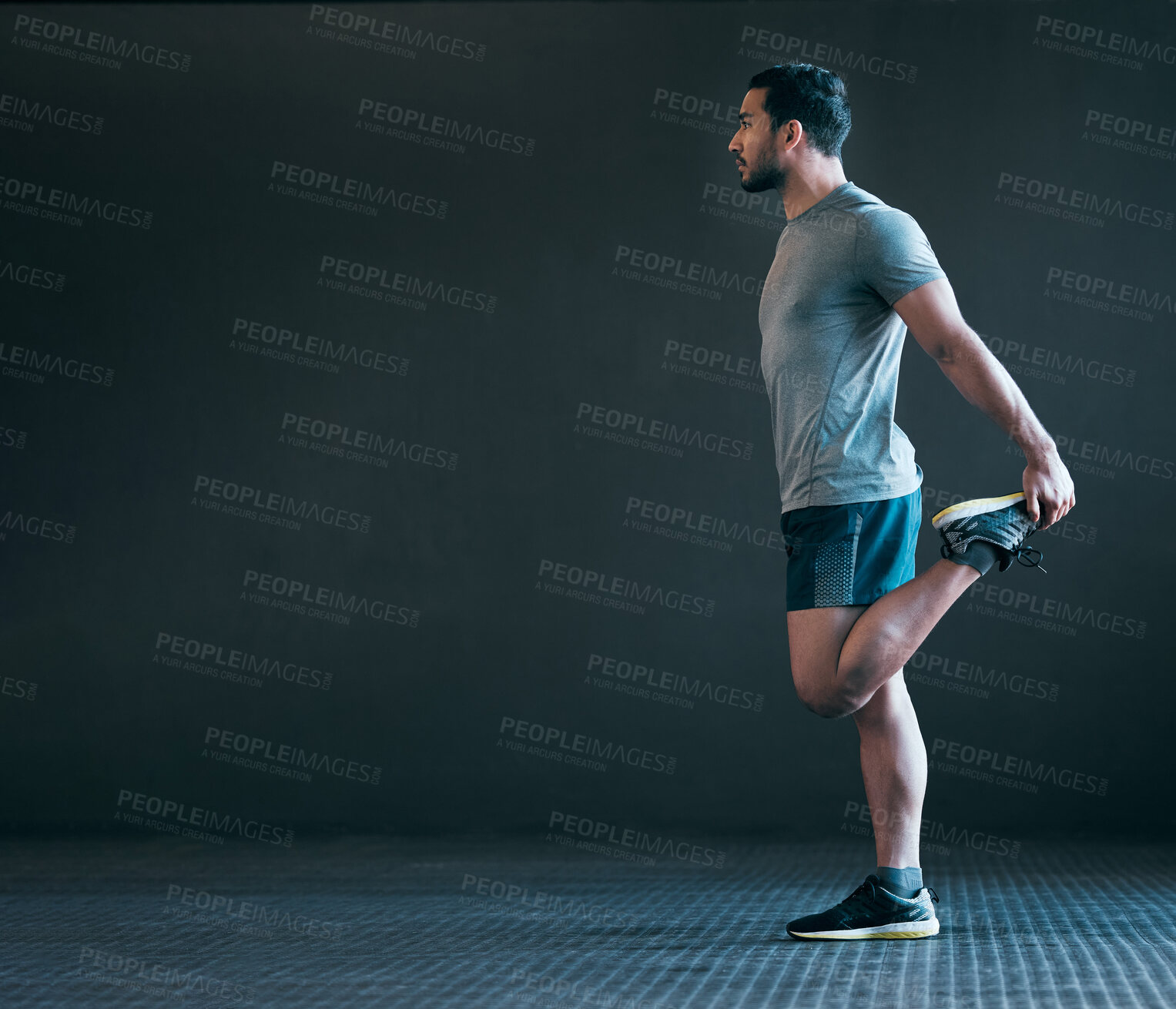 Buy stock photo Stretching legs, fitness and man in gym for exercise, training and warm up for runner workout on gray background. Health, sports and person with mockup space for wellness, performance and flexibility