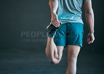 Buy stock photo Rearview shot of an unrecognizable young male athlete warming up against a grey background