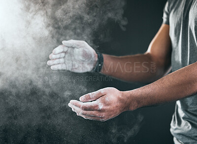 Buy stock photo Cropped shot of an unrecognizable young male athlete applying talcum powder to his hands against a grey background