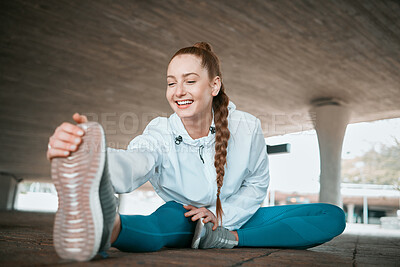 Buy stock photo Shot of a young woman stretching before a run
