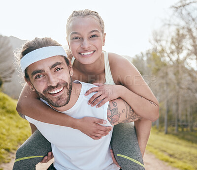 Buy stock photo Shot of a handsome young man giving his girlfriend a piggyback ride while bonding with her during their outdoor workout