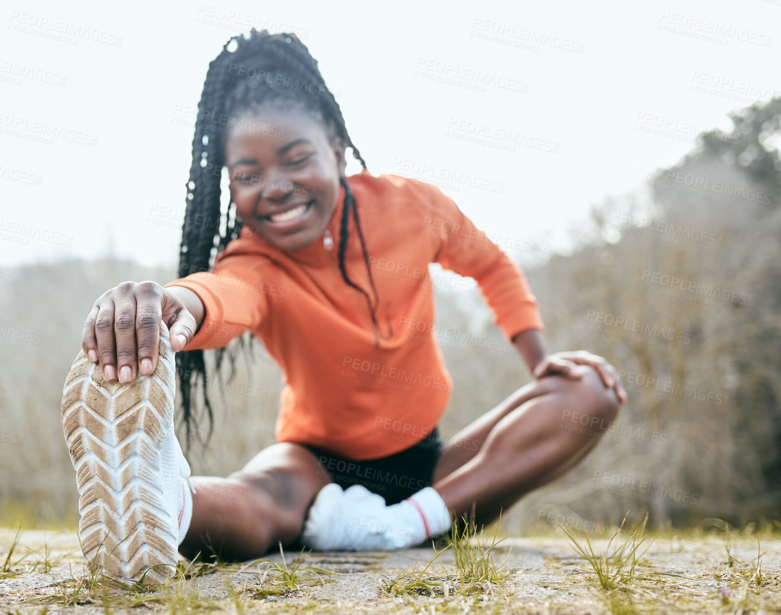 Buy stock photo Black woman, happy and stretching legs in nature for fitness, health and hiking with smile outdoor. Female person, exercise and muscle warm up for workout, wellness and training on ground in forest