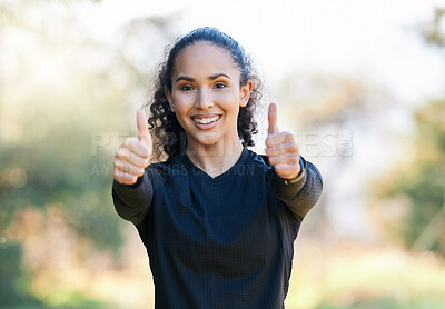 Buy stock photo Portrait of a sporty young woman showing thumbs up while exercising outdoors