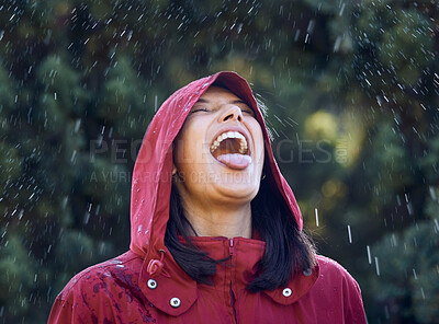 Buy stock photo Drinking, water and woman in rain, outdoor and carefree in winter, holiday and raincoat for weather. Park, girl and happy  to taste with mouth, raindrops and vacation in Washington for nature