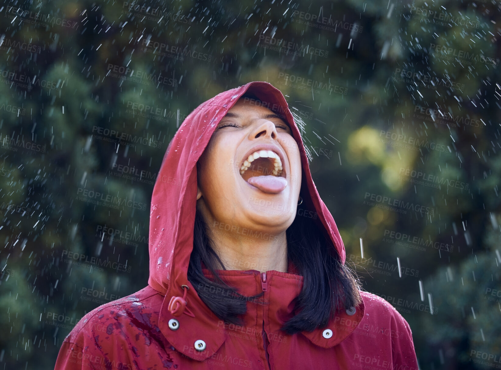 Buy stock photo Drinking, water and woman in rain, outdoor and carefree in winter, holiday and raincoat for weather. Park, girl and happy  to taste with mouth, raindrops and vacation in Washington for nature