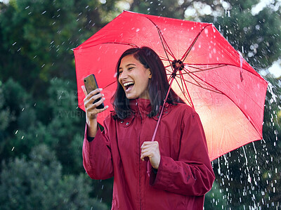 Buy stock photo Umbrella, cellphone and woman with smile, rain and walking on road to work, communication and contact. Outdoor, winter and girl with mobile, reading and excited with news in email for job offer