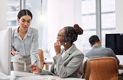 Buy stock photo Shot of a young businesswoman assisting a colleague in a call centre