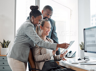 Buy stock photo Shot of a group of businesspeople using a digital tablet together in an office