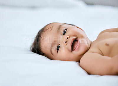 Buy stock photo Shot of an adorable baby girl lying on a bed