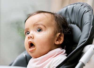 Buy stock photo Shot of an adorable baby girl sitting in her feeding chair