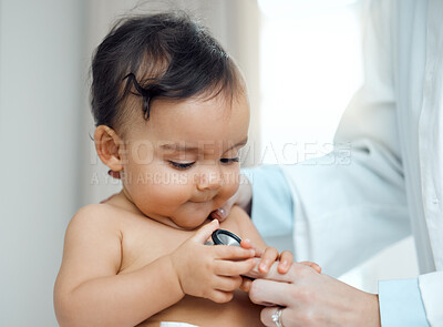 Buy stock photo Baby, stethoscope and hands of doctor in clinic for check up, development and progress for growth. Child, pediatrician and curious of equipment for post natal assessment, healthcare and cardiology