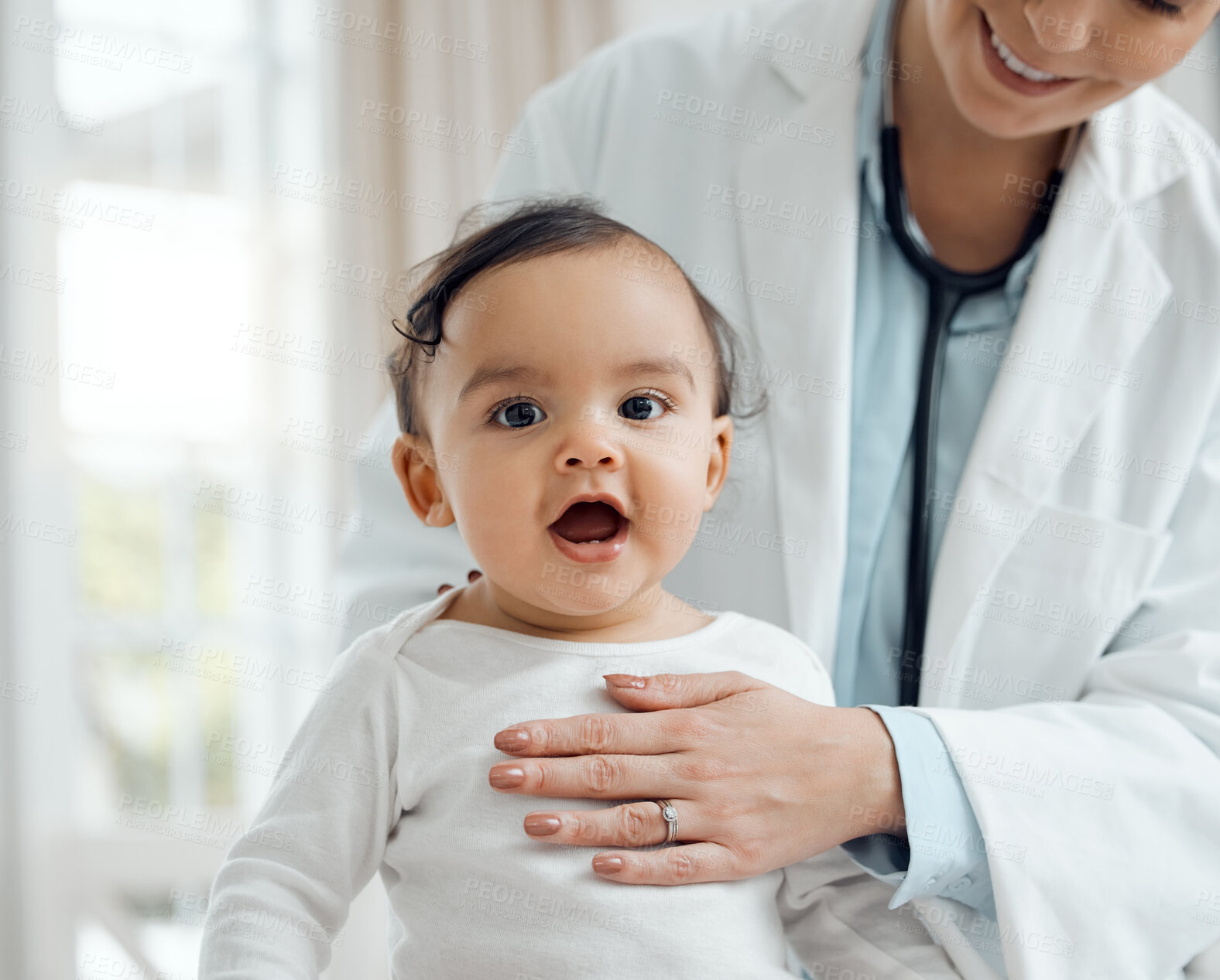Buy stock photo Shot of a paediatrician examining a baby in a clinic