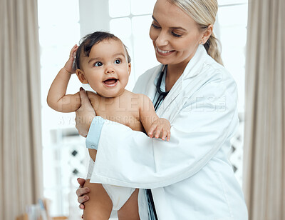 Buy stock photo Shot of a paediatrician examining a baby in a clinic