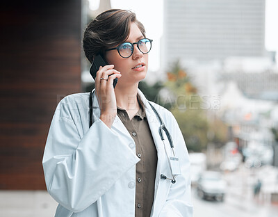 Buy stock photo Woman, doctor and phone call at hospital in city for telehealth, information or service at balcony. Mobile, medical worker and talk to serious contact for healthcare consultation, advice or listening