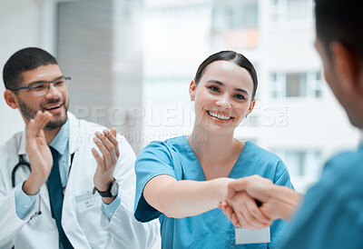 Buy stock photo Shot of a young female doctor shaking hands with a colleague at work
