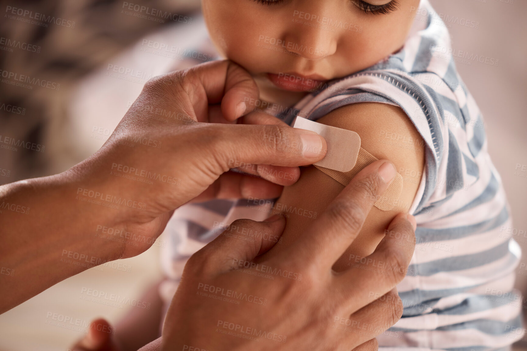 Buy stock photo Child, injury and hand of mother with plaster on arm for wound treatment, helping and care for bruise in home. First aid, person and apply adhesive bandage on son in bedroom with accident and support