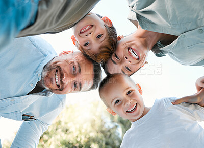 Buy stock photo Shot of a couple spending the day outdoors with their two sons