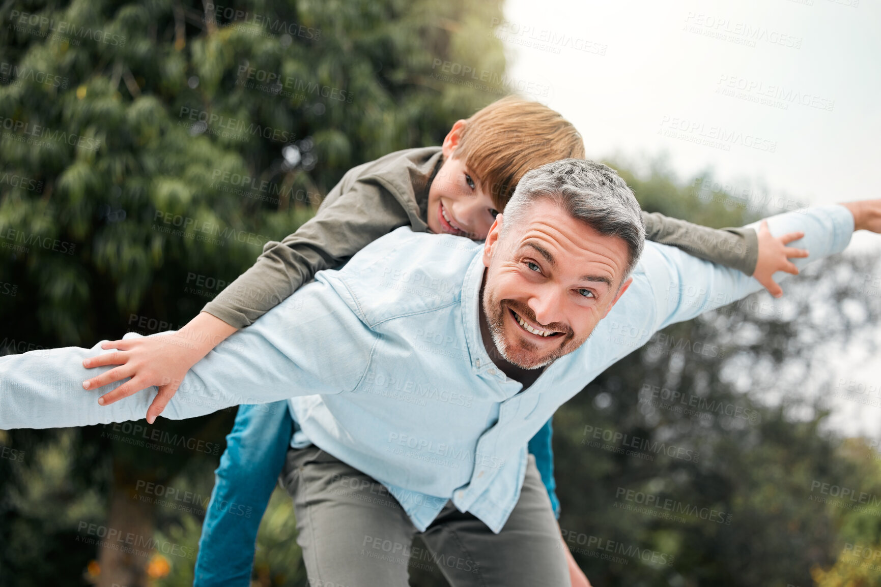 Buy stock photo Portrait, dad and boy with airplane in outdoor for bonding activity, playful fun and childhood happiness in park. Father, kid and back hug in nature for summer adventure, weekend break and affection.