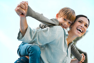 Buy stock photo Shot of a beautiful woman piggybacking her son at the park