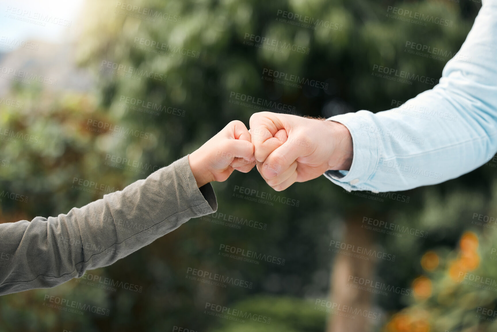 Buy stock photo Parent, child and fist bump with hand for support in nature, outside and family bonding with connection with boy. Relationship, care and motivation for teamwork, park and garden with trust together